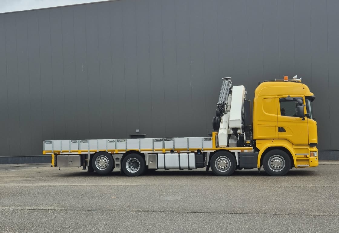Žltá Scania s valníkom a hydraulickou rukou